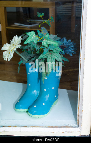 Rubber boots in a shop window Ironbridge Shropshire UK Stock Photo