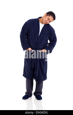 sleepy indian man standing on white background wearing nightgown Stock Photo