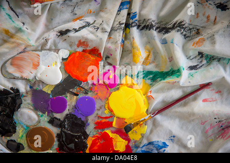 Paint brushes with paints and palette on bright background Stock Photo -  Alamy