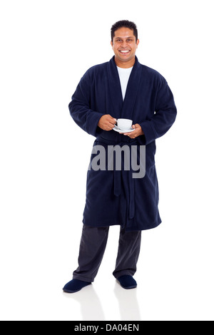 smiling indian man in pajamas drinking coffee in the morning Stock Photo