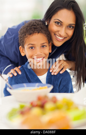 close up portrait of indian mother and son at breakfast table Stock Photo