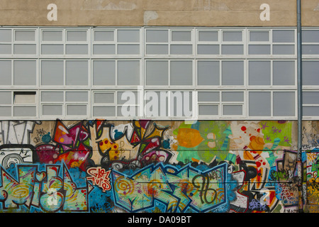 Colourfull graffiti on the wall under the huge window Stock Photo