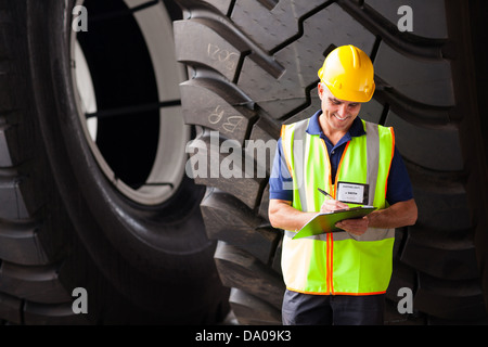 smiling middle aged shipping worker in warehouse Stock Photo