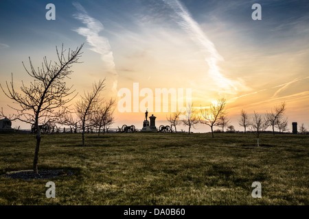 Monuments, cannon and  trees on the Peach Orchard on the Gettysburg National Military Park at sunrise Stock Photo