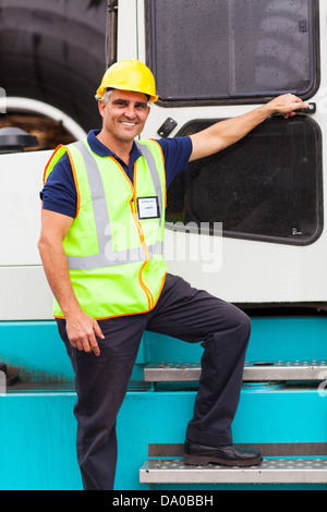 senior harbor forklift driver standing on forklift in container depot Stock Photo