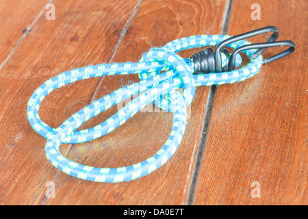 Light blue elastic rope on wood background Stock Photo