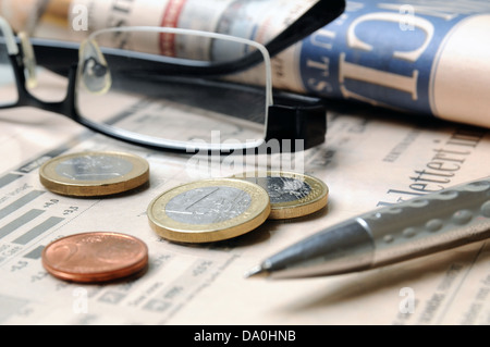 Euro money coins, glasses and ball pen on a financial report Stock Photo