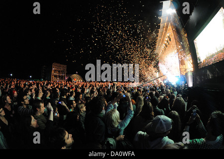 BARCELONA - MAY 23: People watching a concert, while throwing confetti from the stage at Heineken Primavera Sound 2013 Festival. Stock Photo