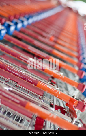 Stacked Sainsbury's shopping trollys, UK. Shot with narrow depth of field Stock Photo