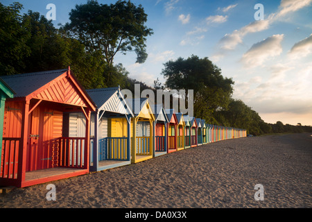 Beach huts at dawn / sunrise Llanbedrog Llyn Peninsula Gwynedd North Wales UK Stock Photo