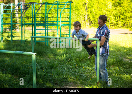 Father with his son on the sportsground Stock Photo