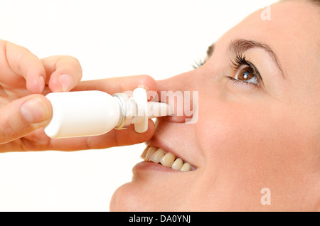 Woman using nasal spray Stock Photo