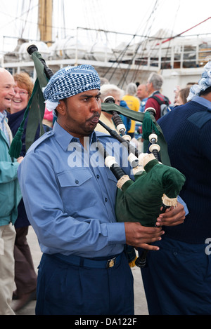 a sailor from the navy of Oman playing the bagpipes at falmouth in cornwall, uk, during the tall ships festival, 2008 Stock Photo