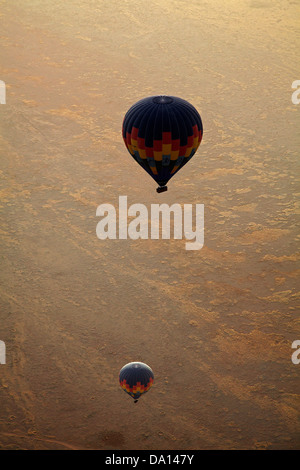 Hot air balloons and early light over Namib Desert, near Sesriem, Namibia, Africa - aerial Stock Photo