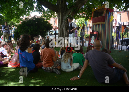Primary school children watch a traditional Punch and Judy show at their annual school fair Stock Photo