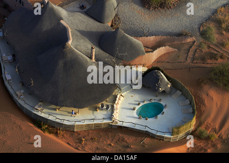 Pool at Little Kulala Lodge, viewed from hot air balloon, near Sesriem, Namibia, Africa - aerial Stock Photo