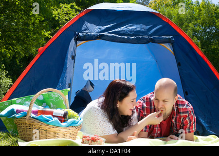 Happy young couple is relaxing on a camping Stock Photo