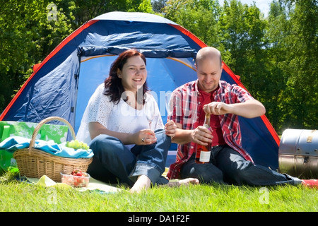 Happy young couple is relaxing on a camping Stock Photo