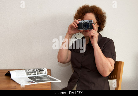 Freelance photographer using a Fuji X100 digital camera Stock Photo