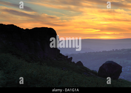 Sunset at the famous Cow and Calf rocks on Ilkley Moor above the West Yorkshire Spa Town of Ilkley, UK Stock Photo