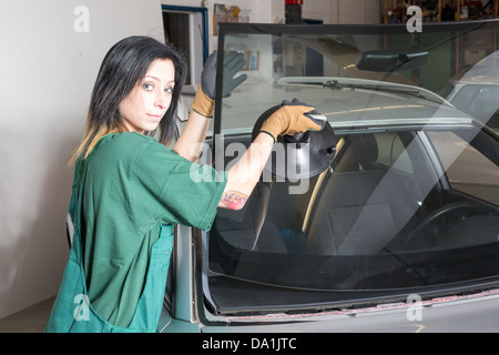Glazier removing windshield or windscreen on a car Stock Photo
