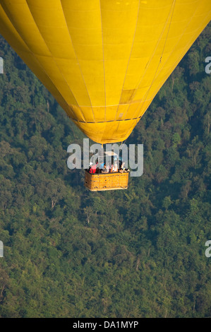 Vertical view of tourists looking at the view from a hot air balloon. Stock Photo