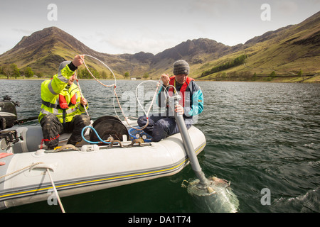 Dr Jeff Warburton of Durham University preparing to take sediment cores from the bottom of Buttermere Lake Stock Photo