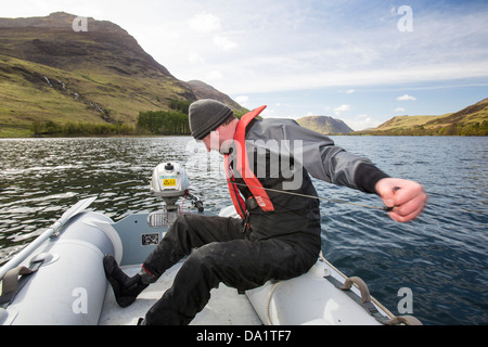 Dr Jeff Warburton of Durham University preparing to take sediment cores from the bottom of Buttermere Lake Stock Photo