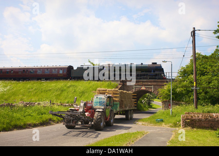 LMS Royal Scot Class 6115 Scots Guardsman steam train at Plumpton on the West Coast Main Line Railway with telehandler. Stock Photo