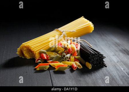 Various Italian pasta on black table Stock Photo