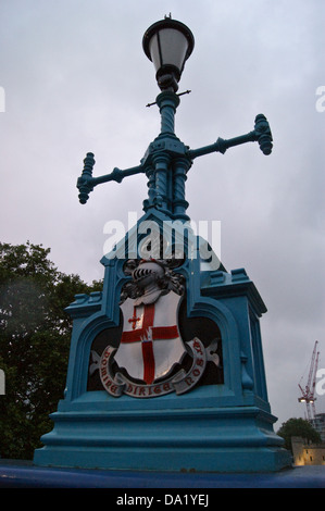 Lamp standard with City of London coat of arms on the approach to Tower Bridge, London, England Stock Photo