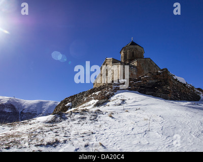 The Gergeti Trinity Church (Tsminda Sameba) in Caucasus Mountains in Georgia. Stock Photo