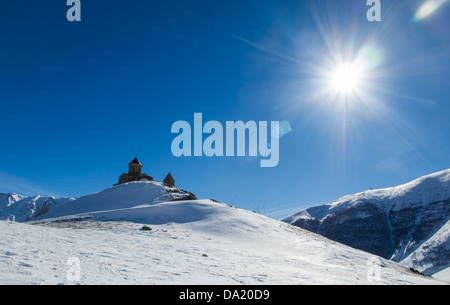 The Gergeti Trinity Church (Tsminda Sameba) in Caucasus Mountains in Georgia. Stock Photo