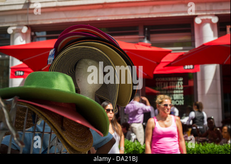 Patrons sit at the outdoor cafe of the Red Rooster restaurant on Lenox Avenue in the neighborhood of Harlem Stock Photo