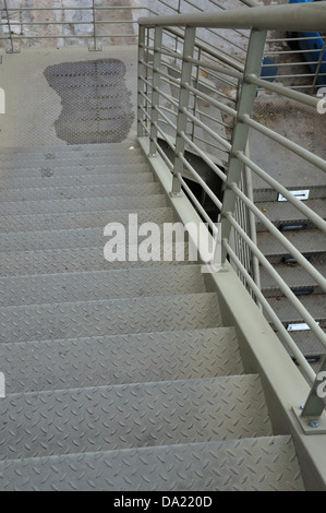 Pedestrian footbridge iron stairway urban overpass bridge above the motorway. Stock Photo