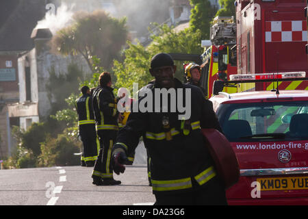 London, UK. 1st July, 2013. Still smouldering, the premisis of The Wheel & Tyre Co, Kensal Green. Credit:  Paul Davey/Alamy Live News Stock Photo