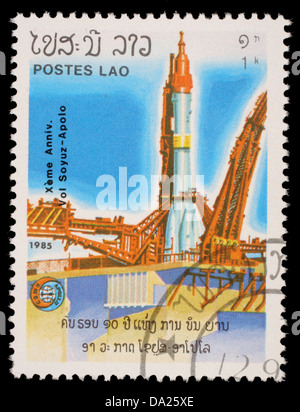 LAOS-CIRCA 1985: A stamp printed in the Laos, is pictured launching the spacecraft Apollo Program Apollo-Soyuz, circa 1985 Stock Photo