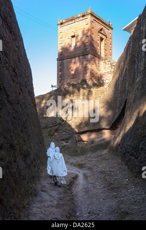 Two women with the traditional white shawl leaving the Bete Medhane Alem Church, Lalibela, Northern Ethiopia Stock Photo