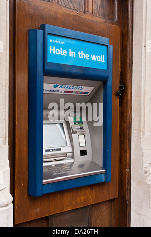 Barclays bank ATM machine in Eton, Berkshire set into an old wooden door, with the inscription 'Hole in the wall'. Stock Photo
