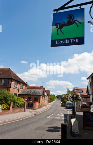 UK village high street - banking group Lloyds TSB sign above bank with iconic black prancing horse. Stock Photo