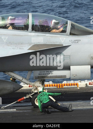 A US Navy F/A-18F Super Hornet fighter aircraft prepares to launch from the aircraft carrier USS Nimitz June 29, 2013 operating in the Arabian Sea. The Nimitz Carrier Strike Group is deployed to the U.S. 5th Fleet area of responsibility conducting maritime security operations, theater security cooperation efforts and support missions for Operation Enduring Freedom. Stock Photo