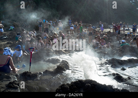 dh Hot Water Beach COROMANDEL NEW ZEALAND People lying in hot water springs thermal pools peninsula Stock Photo