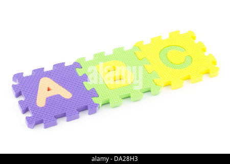 Colored puzzle pieces wit ABC letters isolated on white background Stock Photo