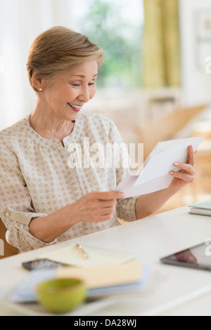 Senior woman reading letter Stock Photo