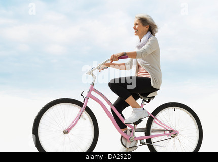 Senior woman riding bicycle Stock Photo