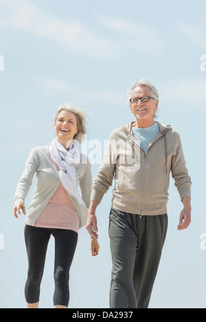 Senior couple walking and holding hands Stock Photo