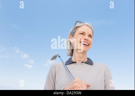 Senior woman holding golf club Stock Photo