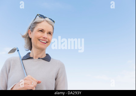Senior woman holding golf club Stock Photo