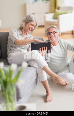 Senior couple using digital tablet at home Stock Photo
