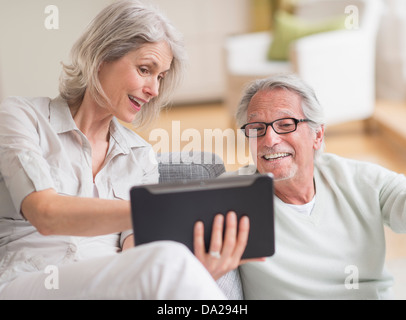 Senior couple using digital tablet at home Stock Photo